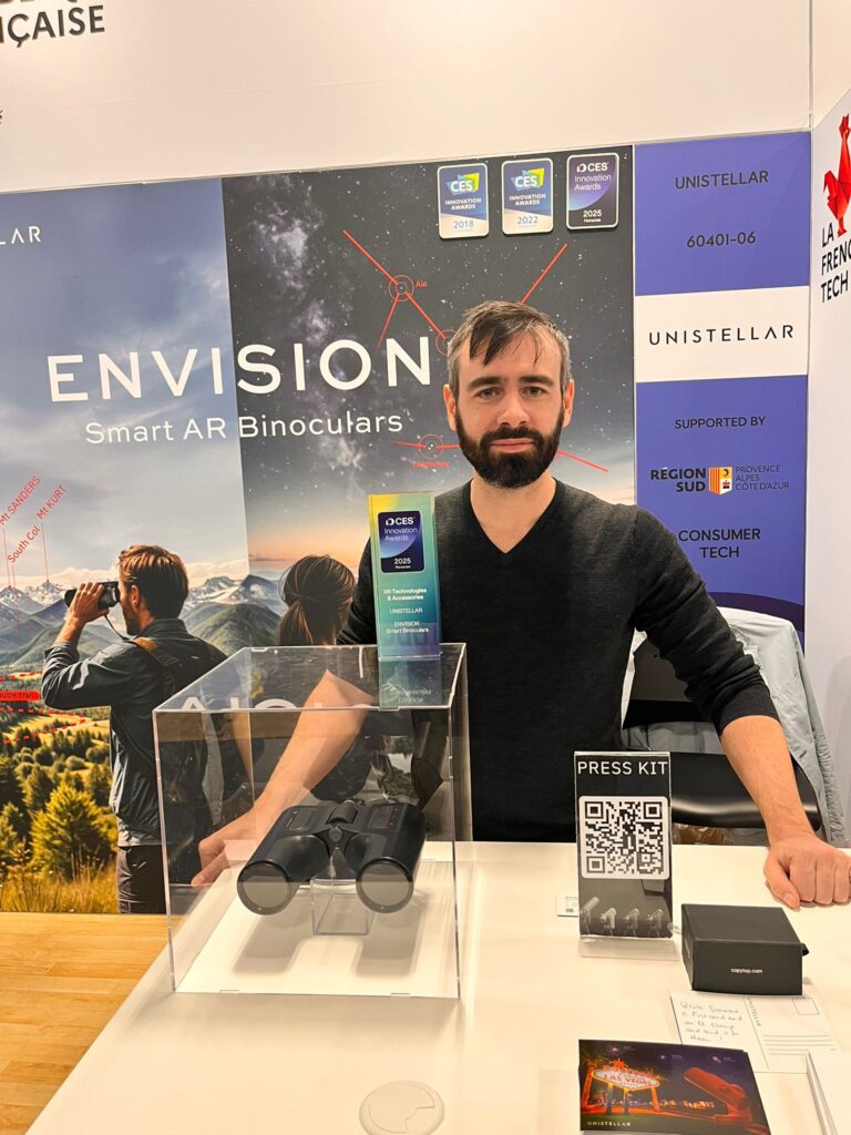Le représentant d'Unistellar pose avec son award sur son stand au CES de Las Vegas.